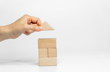 building wood blocks on white background; business or creative concept - 714711948