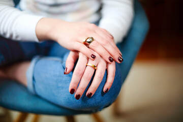 Crop woman with dark manicure wearing rings