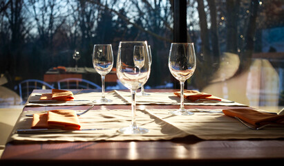 Glasses, fork, knife served for dinner in restaurant