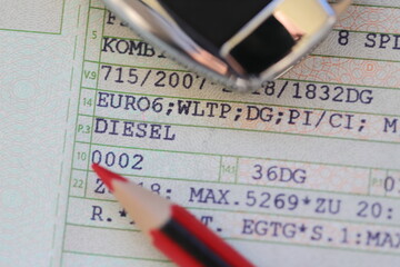 a vehicle registration document with the words (Diesel, Euro 6) and a red pen