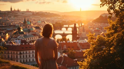  A graceful lady standing with a view of historic buildings in the city of Prague, Czech Republic in Europe. © Joyce