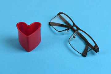 Reading glasses with heart on the side. Concept of the convenience of wearing glasses isolated on...