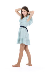 Young beautiful girl in a dress with polka dots on a white background.