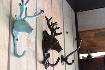 Three vintage wall hooks fixed on a wooden wall
