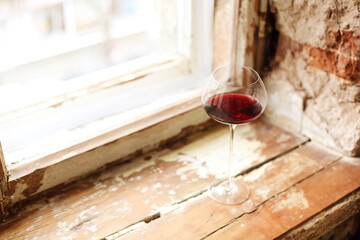 One wineglasse with red wine during party