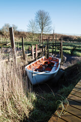 small dingy moored along side wooden pontoon