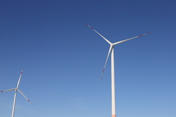 Wind turbine on a field with blue sky