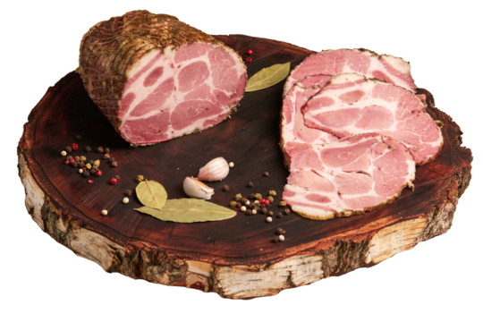 Large piece of pork ham and sliced ham on a kraft wooden board. Delicious baked meat with spices in close-up. Top view. Isolated on a transparent background