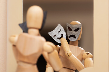 Angry, dangerous mannequin puts on cute cheerful mask in front of mirror, concept of danger,...