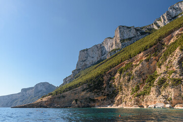 The cliffed coast of the Orosei gulf and the bay Cala Mariolu in east Sardinia seen from the sea