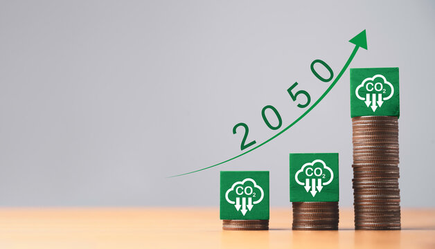 Reduction carbon emission symbol on increasing coins stacking for carbon footprint to limit global warming from climate change in Kyoto protocol within 2050 , Carbon credit can make money concept.