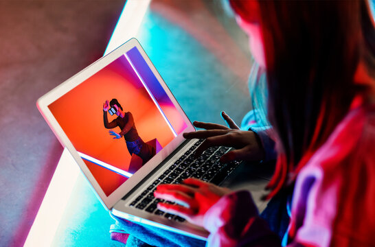 Teen girl watching video on laptop - Powered by Adobe