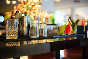 Bar counter with bottles in blurred background