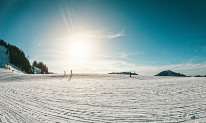 People skiing in alps mountains on sunny day - Snow winter sports and vacation concept - Focus on...