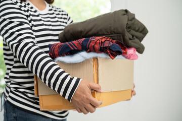 Donation box with used clothes at home to support help for poor people in the world.