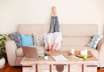 Young woman reading book at home