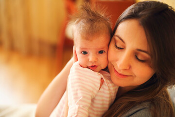 Young mother holding her newborn child. Mom nursing baby