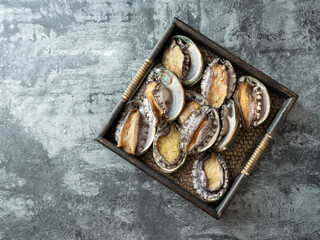Fresh abalone on wooden tray	