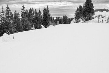 mountain road covered in snow. mountain road in winter in black and white. black and white landscape of a snowy road. pure snow covered road in black and white