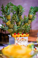 Fruit decoration at a wedding reception with pineapples and oranges