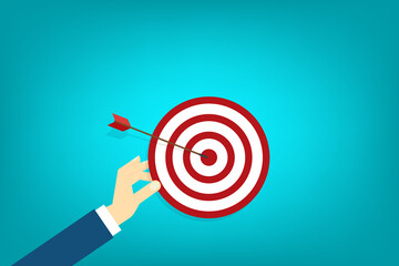 Hand holding a target, showing a goal. Red arrow hits the center. Business challenge failure and success concept.	