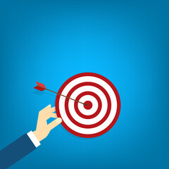 Hand holding a target, showing a goal. Red arrow hits the center. Business challenge failure and success concept.	