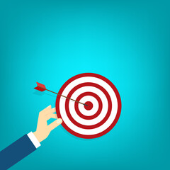 Hand holding a target, showing a goal. Red arrow hits the center. Business challenge failure and success concept.	