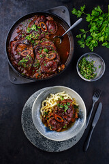 Traditional braised Italian ossobuco alla Milanese with gremolata and spaetzle served in a Nordic design plate