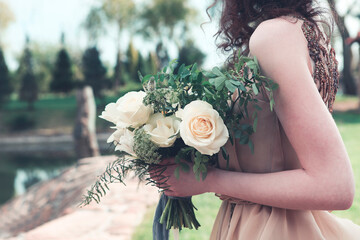 Woman in boho dress holding lush bouquet