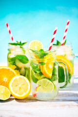Glasses of citrus lemonade near pool