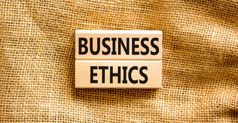 Business ethics symbol. Concept words Business ethics on beautiful wooden blocks. Beautiful canvas...