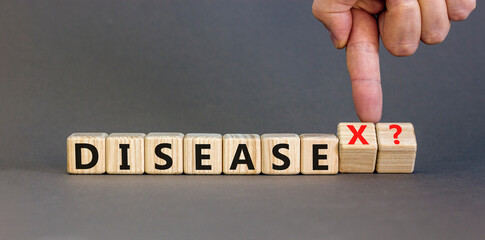 Disease X after covid symbol. Turned cubes and changed the word Disease to Disease X. Beautiful grey table grey background. Doctor hand. Medical, Disease X after covid concept. Copy space.