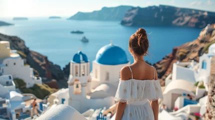Foto op Canvas Carefree girl tourist in European destination wearing white fashion dress, Santorini, Greece island.Santorini travel tourist woman on vacation in Oia walking on stairs in summer,Europe travel vacation © Amonthep