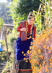 a girl with Gurung traditional dressing a Gurung village in Ghandruk town, Gandaki Province of Nepal, is a point of Annapurna circuit trek and Poonhill trekking in Nepal  - 714798111