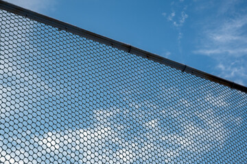 Metal fence on a blue sky background