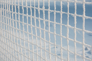 Detail of a chain-link fence, covered with hoarfrost