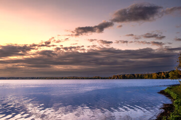 Sunrise over the lake in the early summer morning.