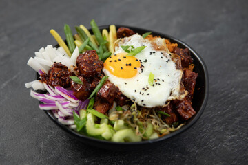 bibimap bowl with tofu, egg, celery, kimchi and black sesame