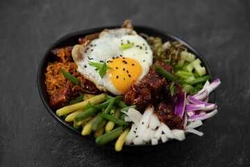 bibimap bowl with tofu, egg, celery, kimchi and black sesame - obrazy, fototapety, plakaty