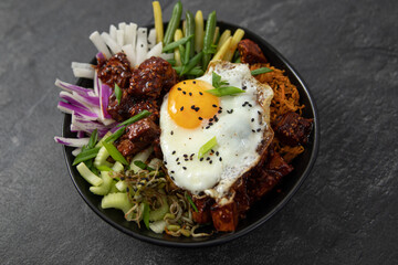 bibimap bowl with tofu, egg, celery, kimchi and black sesame - obrazy, fototapety, plakaty
