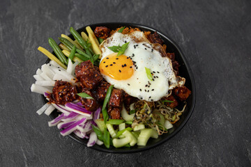 bibimap bowl with tofu, egg, celery, kimchi and black sesame