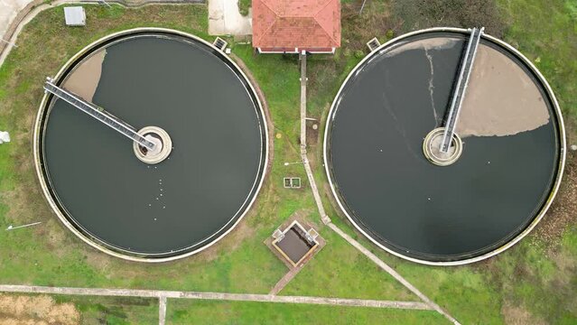 Two circular wastewater treatment pools in a facility.