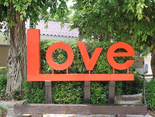 Text the LOVE sign label in the love garden for the backdrop take photos with a flower background on Valentine's Day