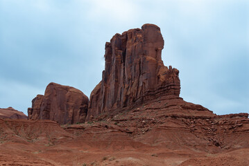 Fototapeta na wymiar Desert landscape with red rocks and dry vegetation on red sands in Monument Valley, Navajo Nation, Arizona - Utah