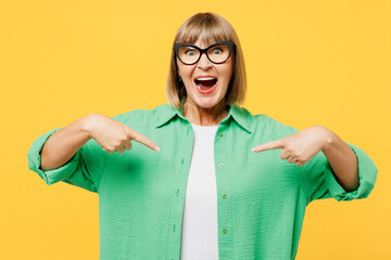 Elderly excited happy fun blonde woman 50s years old she wear green shirt glasses casual clothes...