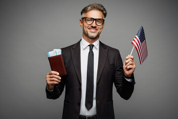 Traveler employee business man corporate lawyer wear black suit hold passport ticket American flag...