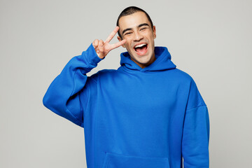 Young cheerful happy smiling satisfied fun middle eastern man he wear blue hoody casual clothes...