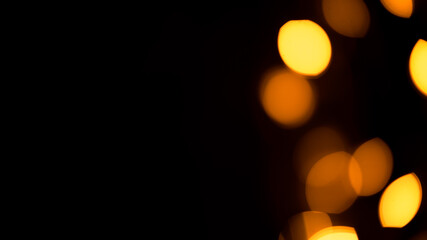 Bright yellow, gold lights, bokeh on black background