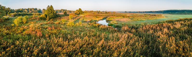 Sunrise among meadows and forests on the Suprasl River in Podlasie on an autumn,september day.