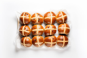 A dozen delicious Easter hot cross buns on a white cloth against a white isolated background, photo taken from above.